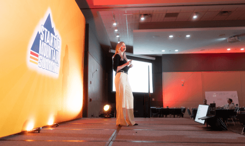 A speaker on the Summit stage